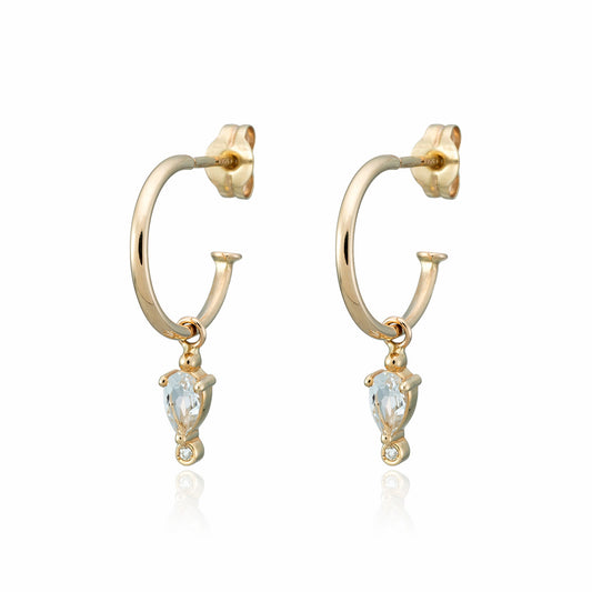 A white render of a pair of gold huge hoop earrings with free hanging diamond charm.
