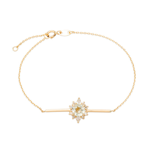 A white render of a dainty gold bar bracelet with halo diamond centrepiece shaped like a lotus flower